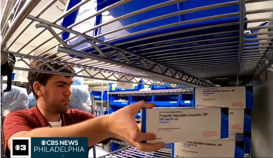 Young man at work loading boxed onto shelf.